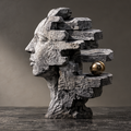 Opposite angle of the layered bust and reflective gold-tone orb