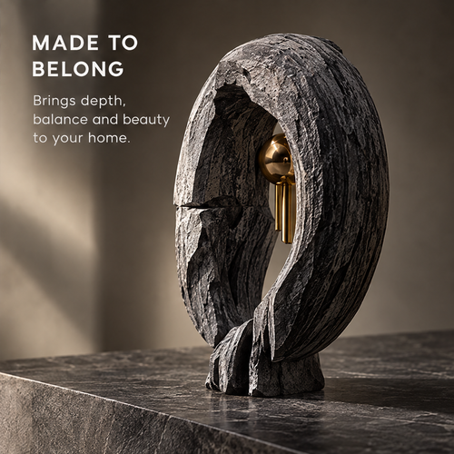 Charcoal-gray textured halo sculpture with a gold-tone orb, front view without text