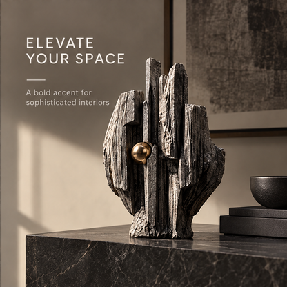 Front view of layered charcoal-gray peak sculpture with a gold-tone orb, without text